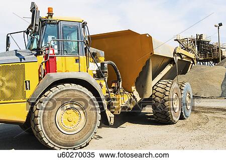Stock Photography - Dump truck in gravel quarry. Fotosearch