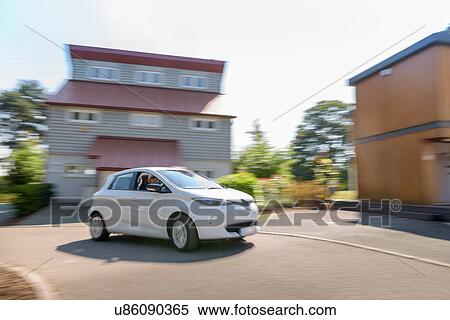Electric car driving through neighbourhood View Large Photo Image Stock Photography - Electric car driving through neighbourhood. Fotosearch