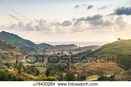 Picture - Elevated landscape and distant sea, Mawi Beach, Lombok, Indonesia. Fotosearch