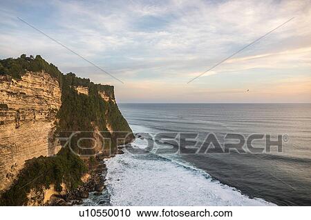 Stock Image - Elevated view of cliffs and sea, Uluwatu, Bali, Indonesia. Fotosearch