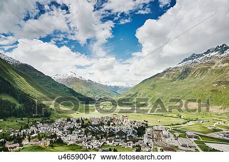 Stock Photo - Elevated view of mountains and valley village, Andermatt, Switzerland. Fotosearch