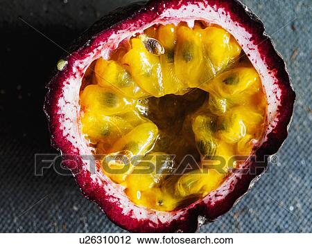 Stock Image - Elevated view of passion fruit cut in half. Fotosearch