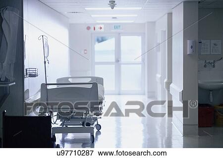Stock Photo - Empty hospital bed with intravenous drip in hospital ward. Fotosearch
