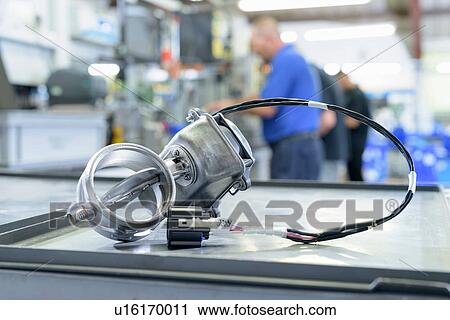 Stock Image - Exhaust valve with actuator on production line in factory. Fotosearch