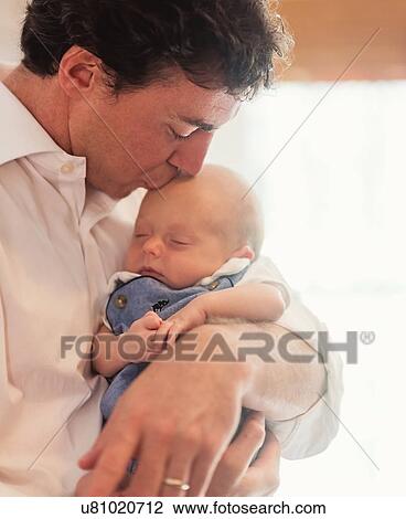 Stock Image - Father kissing baby son (0-1 months). Fotosearch