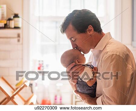 Father kissing baby son (0-1 months) View Large Photo Image Stock Photo - Father kissing baby son (0-1 months). Fotosearch