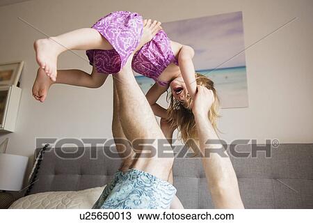 Father lifting daughter (2-3) with legs View Large Photo Image Stock Image - Father lifting daughter (2-3) with legs. Fotosearch