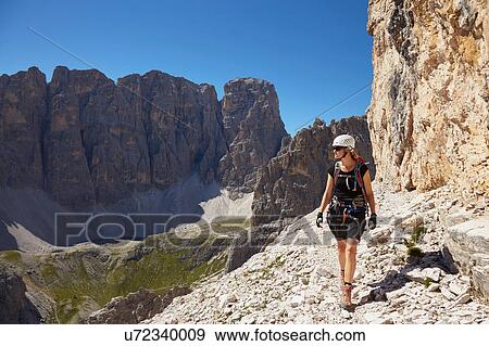 Female hiker hiking in Dolomites, Sexten, South Tyrol, Italy View Large Photo Image Stock Photo - Female hiker hiking in Dolomites, Sexten, South Tyrol, Italy. Fotosearch