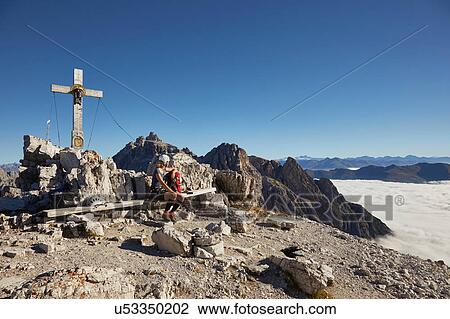 Female hiker sitting on Paternkofel mountain bench, Dolomites, Sexten, South Tyrol, Italy View Large Photo Image Stock Image - Female hiker sitting on Paternkofel mountain bench, Dolomites, Sexten, South Tyrol, Italy. Fotosearch