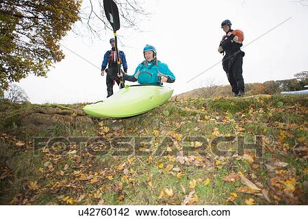 Female kayakers preparing to move down river bank in kayak View Large Photo Image Stock Image - Female kayakers preparing to move down river bank in kayak. Fotosearch