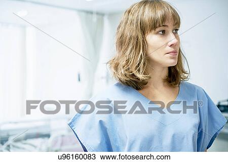 Stock Image - Female nurse in hospital ward. Fotosearch