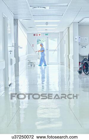 Female nurse pushing bed on hospital corridor View Large Photo Image Stock Image - Female nurse pushing bed on hospital corridor. Fotosearch