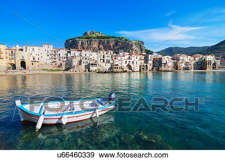 Stock Photo - Fisherman's boat near old town waterfront and La rocca, Cefalu, Sicily, Italy. Fotosearch