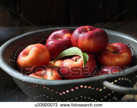 Stock Image - Fresh organic fruit, donut nectarines. Fotosearch