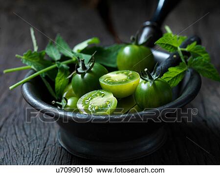 Stock Image - Fresh organic fruit, sweet green cherry tomatoes. Fotosearch