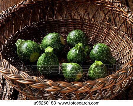 Stock Image - Fresh organic vegetables, baby round courgettes. Fotosearch