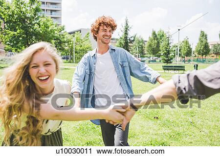 Friends circle dancing in park View Large Photo Image Stock Image - Friends circle dancing in park. Fotosearch