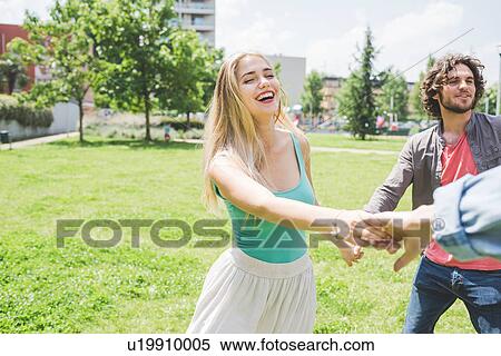 Stock Photography - Friends circle dancing in park. Fotosearch