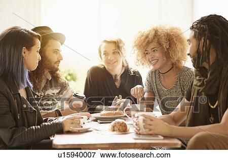 Friends having coffee together in cafe View Large Photo Image Stock Photo - Friends having coffee together in cafe. Fotosearch