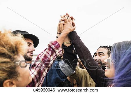 Friends holding their hands together View Large Photo Image Stock Photograph - Friends holding their hands together. Fotosearch
