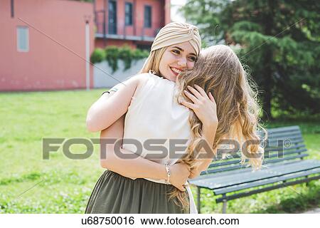 Friends hugging in park View Large Photo Image Stock Photograph - Friends hugging in park. Fotosearch