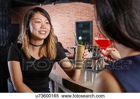 Friends in bar making a toast View Large Photo Image Stock Photography - Friends in bar making a toast. Fotosearch