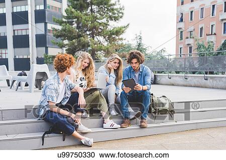 Stock Image - Friends on social media outdoors. Fotosearch