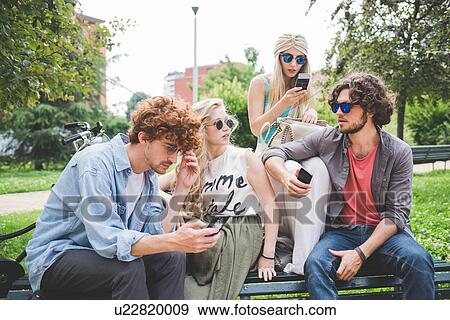 Friends on social media outdoors View Large Photo Image Stock Photo - Friends on social media outdoors. Fotosearch
