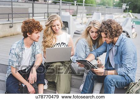 Stock Photo - Friends on social media outdoors. Fotosearch