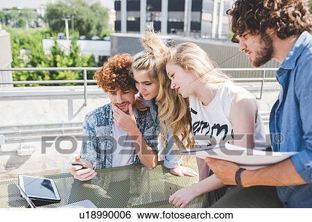 Friends on social media outdoors View Large Photo Image Stock Photograph - Friends on social media outdoors. Fotosearch