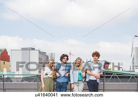 Friends standing together against rail View Large Photo Image Stock Image - Friends standing together against rail. Fotosearch