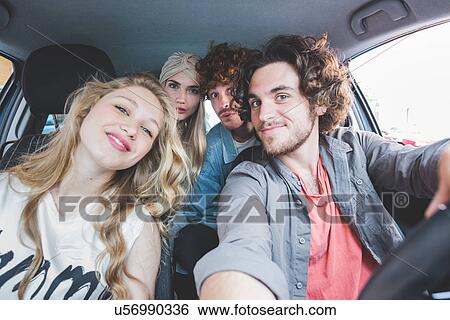 Friends taking selfie in car View Large Photo Image Stock Photograph - Friends taking selfie in car. Fotosearch