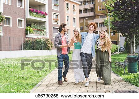 Stock Photo - Friends walking in park. Fotosearch