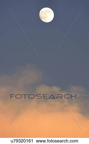 Stock Image - Full moon at dusk. Fotosearch