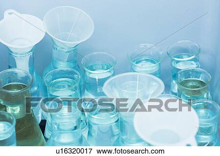 Funnels and beakers filled with liquid View Large Photo Image Stock Photo - Funnels and beakers filled with liquid. Fotosearch