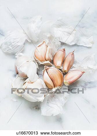 Stock Image - Garlic bulbs and cloves on white background. Fotosearch