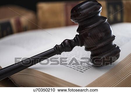 Stock Image - Gavel on open law book. Fotosearch