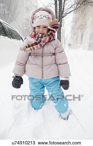 Girl (2-3) in winter clothing standing on snow View Large Photo Image Stock Image - Girl (2-3) in winter clothing standing on snow. Fotosearch