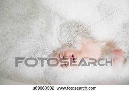Girl (2-3) lying in bathtub View Large Photo Image Stock Image - Girl (2-3) lying in bathtub. Fotosearch
