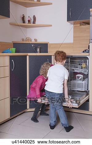 Girl (4-5) and boy (8-9) loading dishwasher View Large Photo Image Stock Photography - Girl (4-5) and boy (8-9) loading dishwasher. Fotosearch