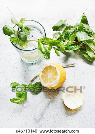 Glass of water with lemon and mint View Large Photo Image Stock Image - Glass of water with lemon and mint. Fotosearch
