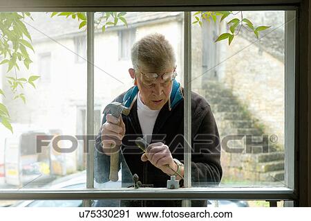 Stock Image - Glazier at work. Fotosearch