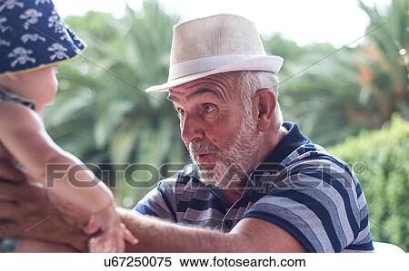 Grandfather making faces at baby boy View Large Photo Image Stock Photography - Grandfather making faces at baby boy. Fotosearch