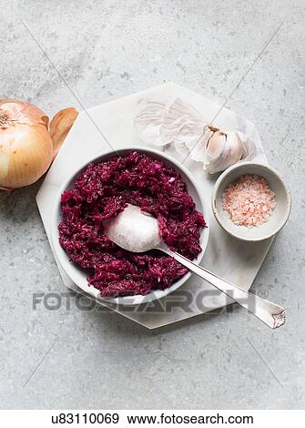 Stock Photo - Grated beetroot with pink sea salt and garlic. Fotosearch