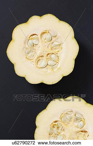 Stock Image - Green pumpkin cut in half. Fotosearch