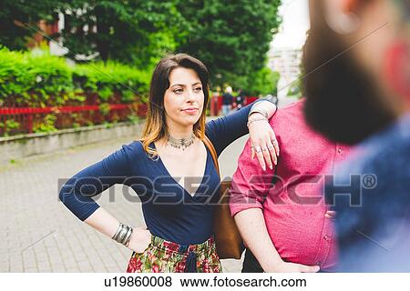 Group of friends chatting by roadside View Large Photo Image Stock Photo - Group of friends chatting by roadside. Fotosearch
