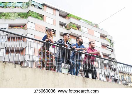 Group of friends enjoying view from bridge View Large Photo Image Stock Photograph - Group of friends enjoying view from bridge. Fotosearch