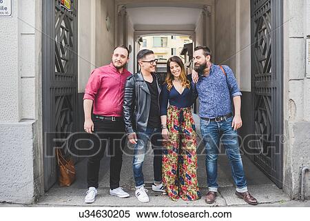 Stock Photography - Group of friends in front of building entrance. Fotosearch