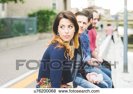 Group of friends sitting by roadside View Large Photo Image Stock Photo - Group of friends sitting by roadside. Fotosearch