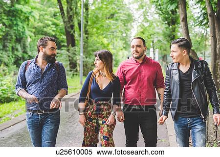 Group of friends walking in park View Large Photo Image Stock Photography - Group of friends walking in park. Fotosearch